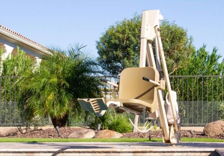 aqua creek pool lift mounted on a pool deck