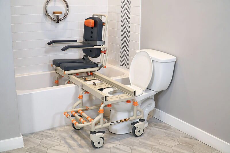 shower-chair-petite-range shower chair being lifted over bathtub with supporting frame