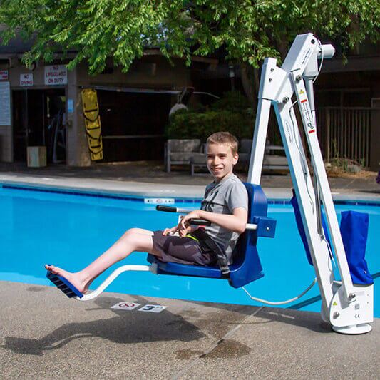 pool-lifts Person in pool life seat mounted near pool