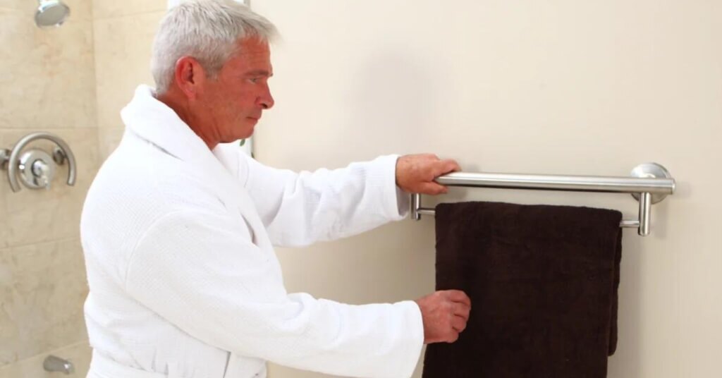 Man Using Grab Bar In Bathroom
