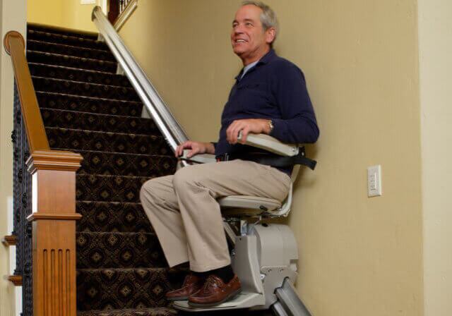 Man going up stairs in Bruno Elan Stairlift