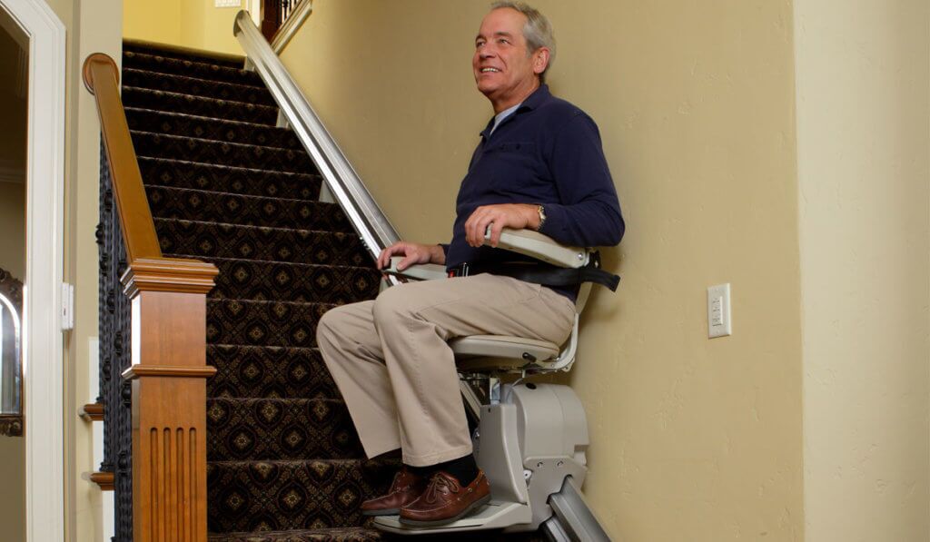 Man going up stairs in Bruno Elan Stairlift