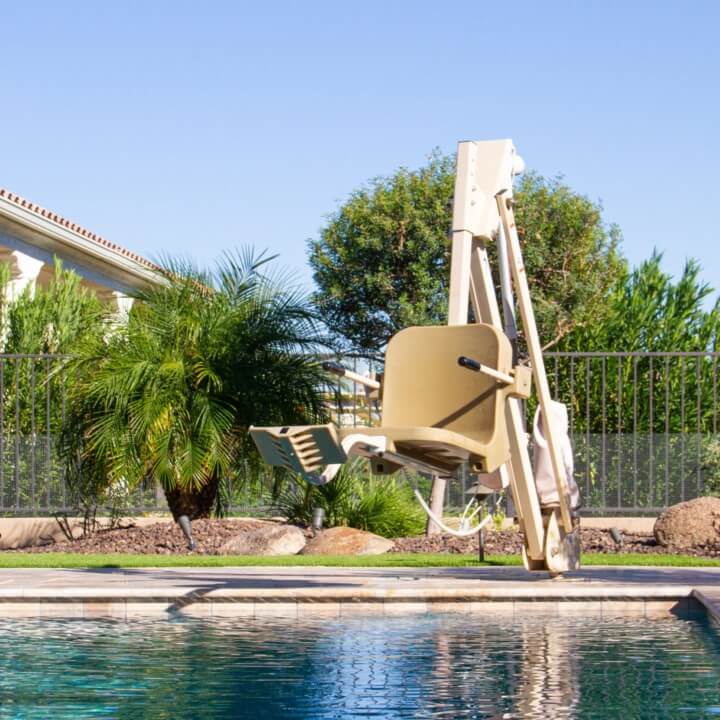 aqua creek pool lift mounted on a pool deck